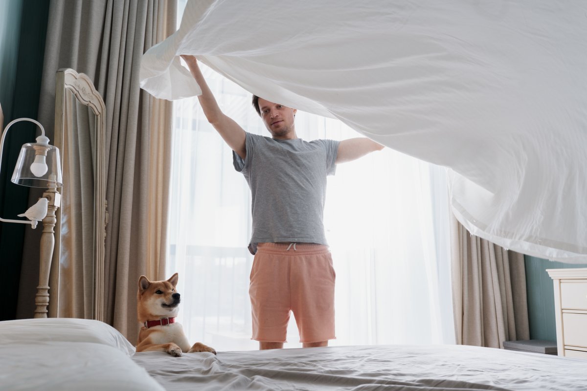 A man puts a duvet cover on