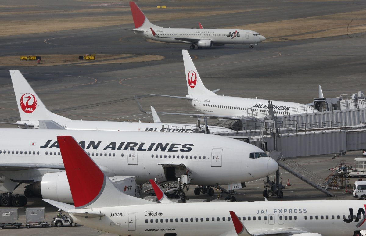 Japan Airlines planes sit on the tarmac