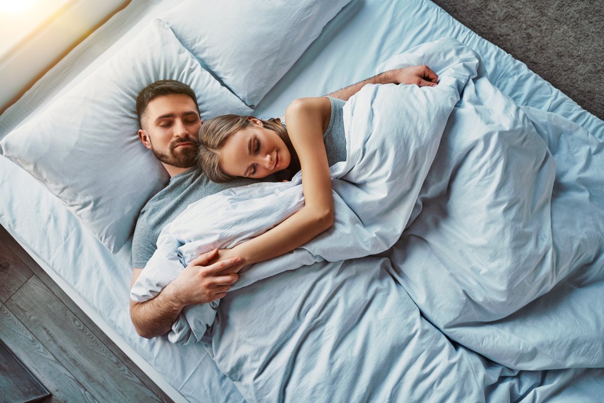 Couple asleep in bed