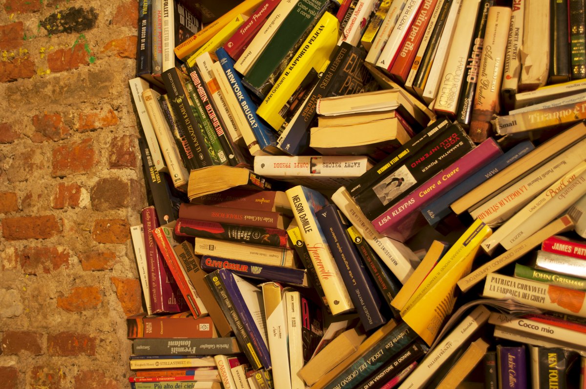 Books Stacked Together In Brick Wall