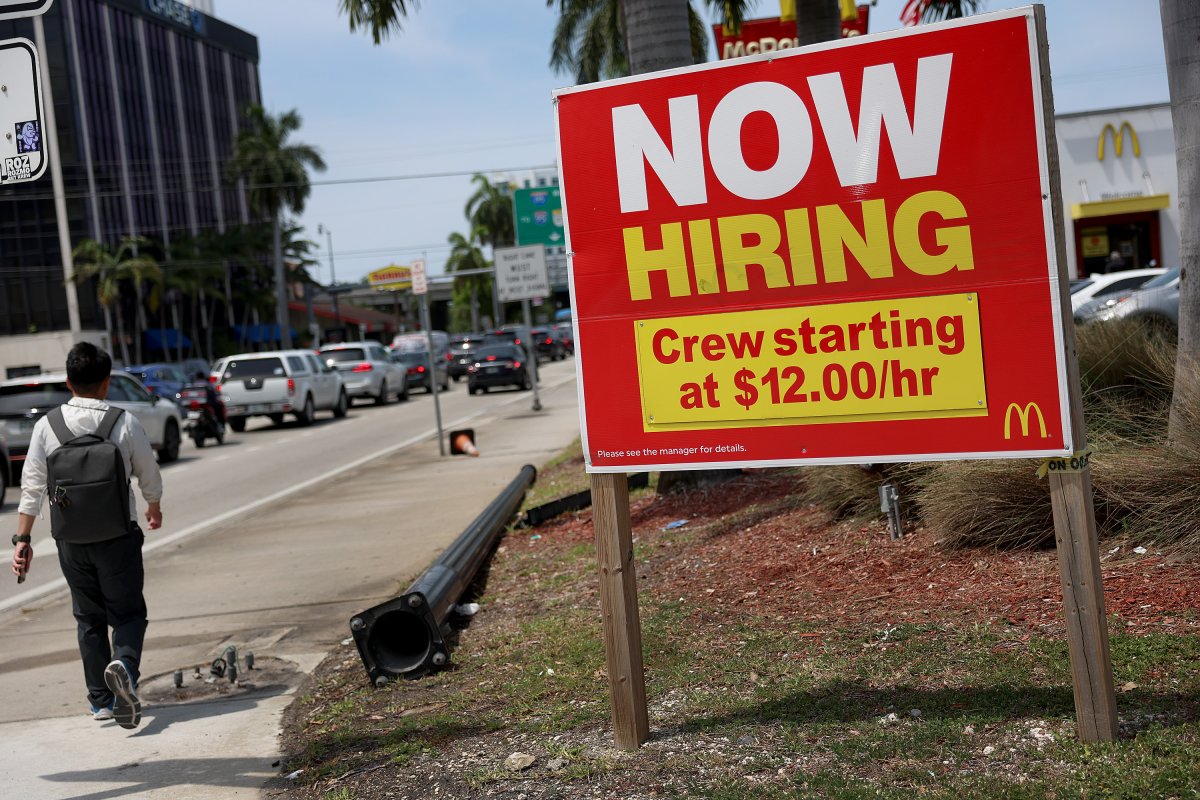 A 'Now Hiring' sign posted outside