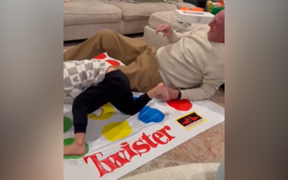 Ken Whitaker take a tumble playing Twister.
