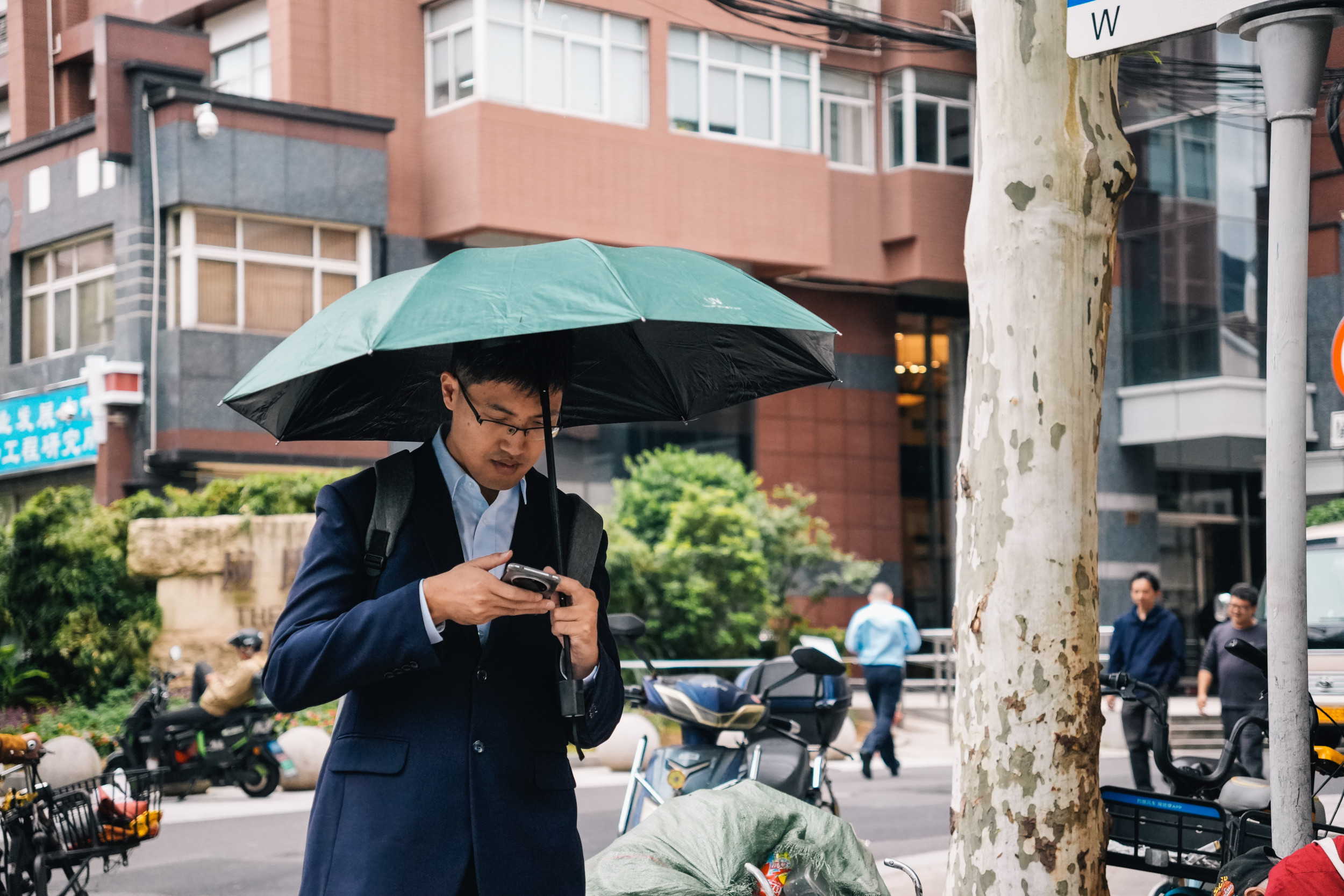 man suit rain on phone