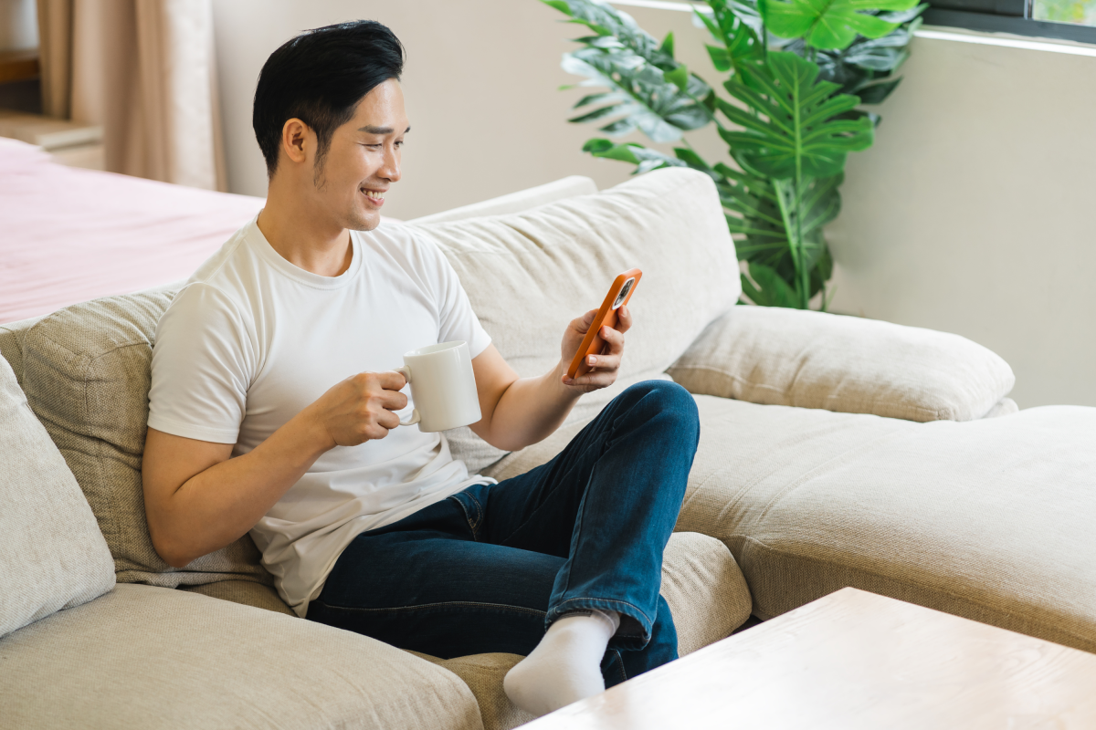 Man Sitting Sofa Home Mobile Phone Coffee