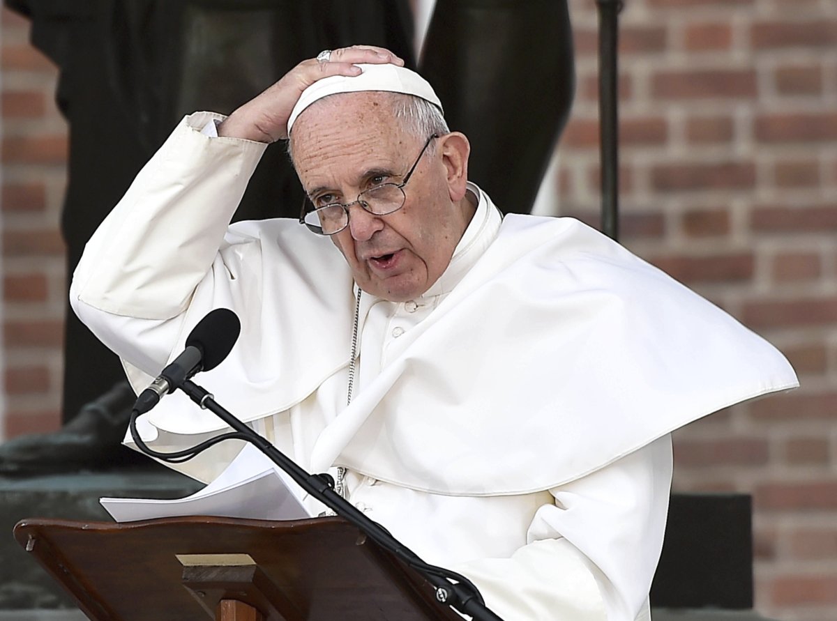 Pope Francis speaks into a mic 