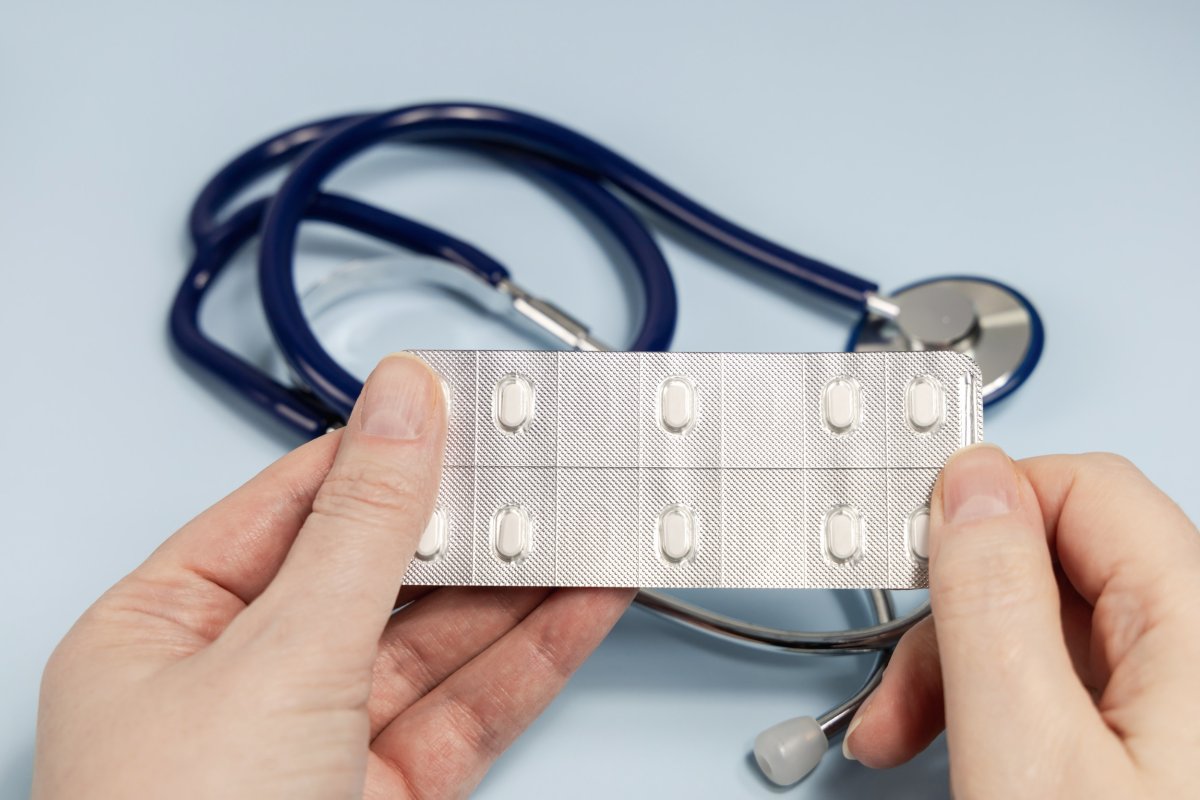 A doctor holds a pack of antidepressants