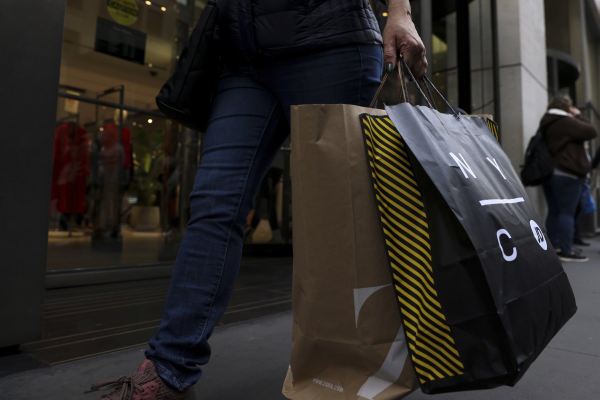 A shopper carries bags down Fifth Avenue