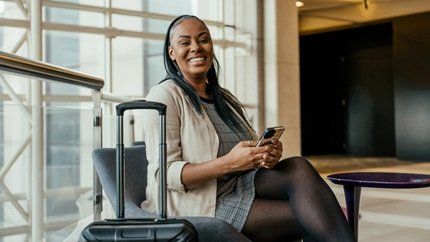Woman with suitcase in lobby