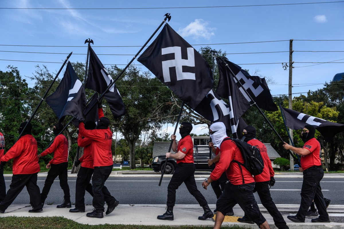 People hold swastika flags