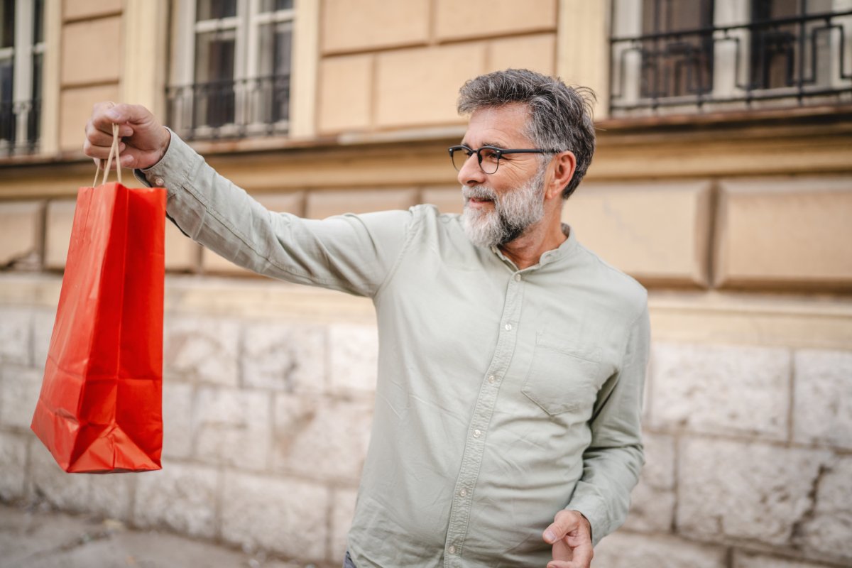 A man holds a shopping bag