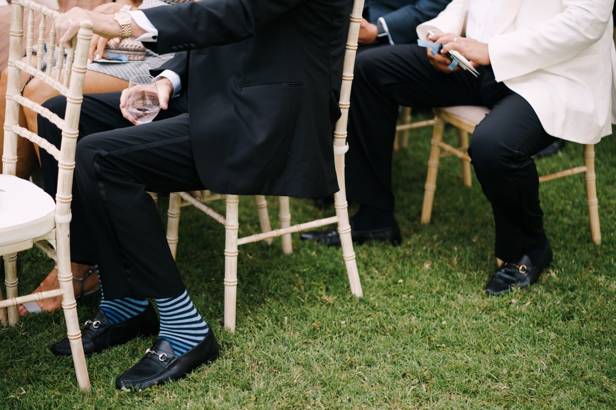 Guests sit outside at a wedding