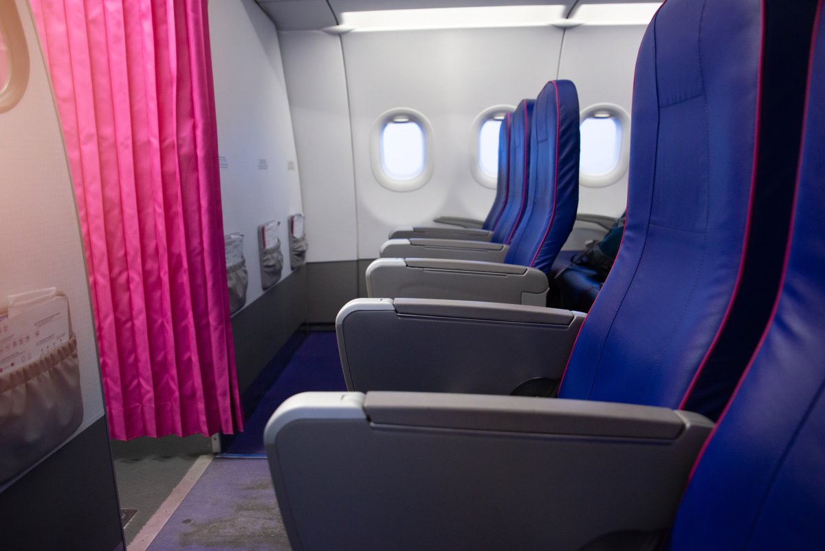 Empty first row of seats on plane.