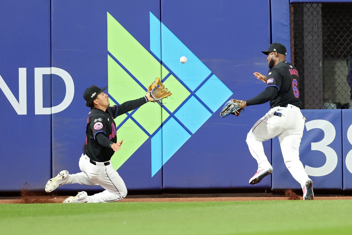 Mets outfielders try to avoid collision.
