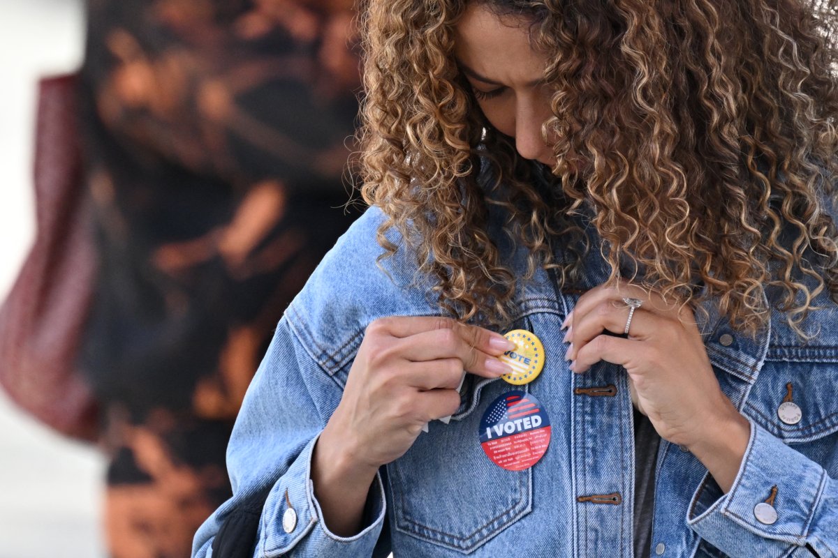A young woman attaches a pin