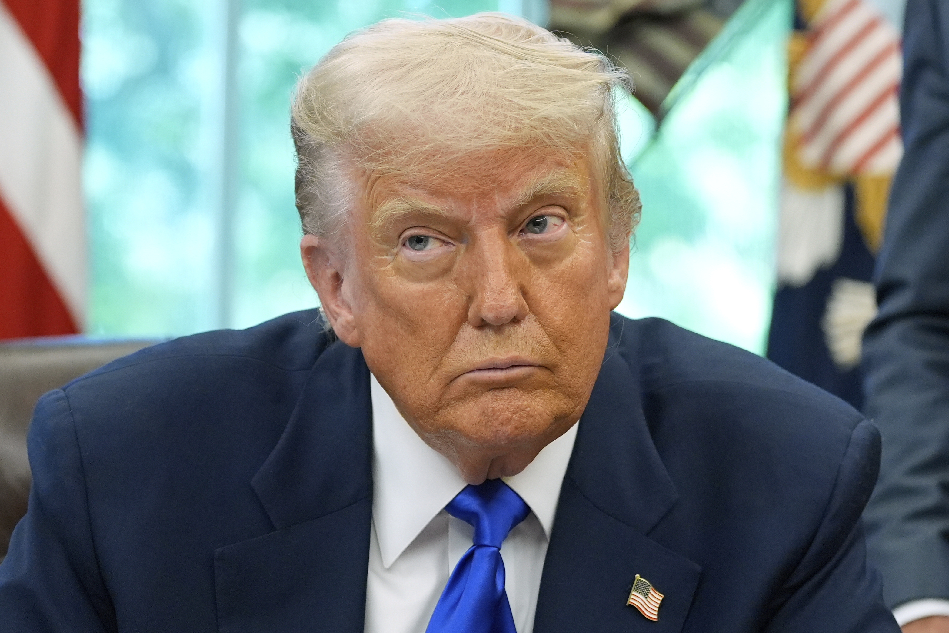 President Donald Trump speaks with reporters