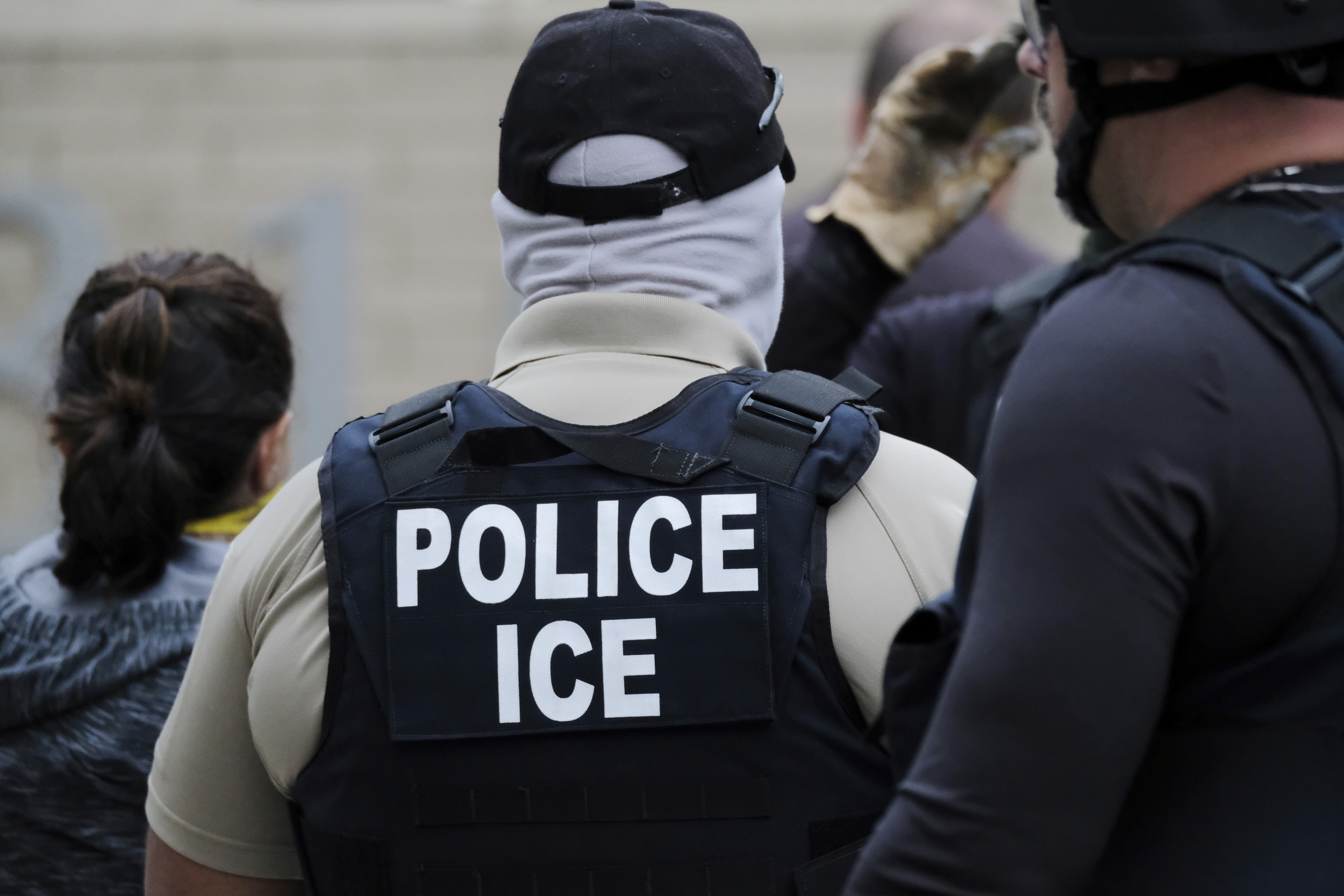 ICE agent arresting immigrant