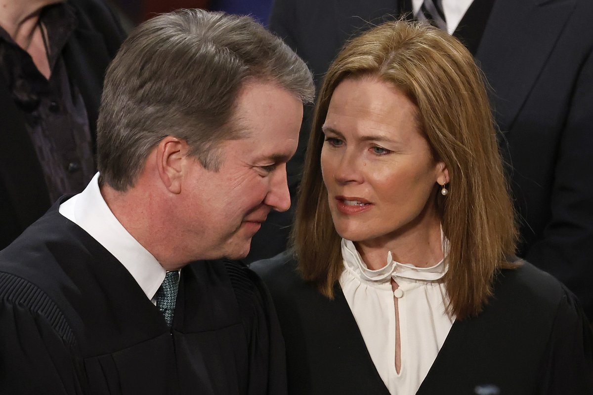 Amy Coney Barrett talks with Brett Kavanaugh