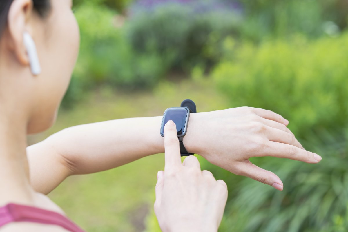 A woman checks her smart watch
