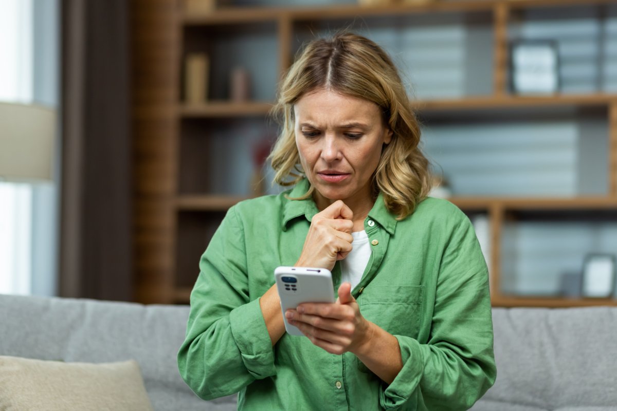 Upset woman looking at phone