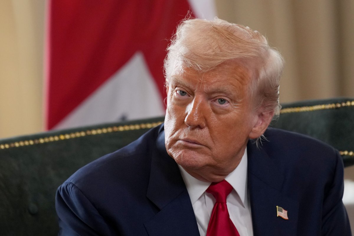 President Donald Trump listens as he meets 