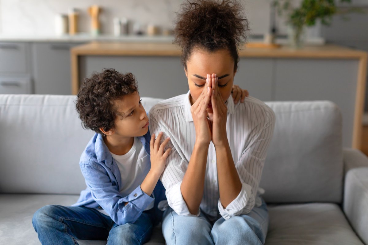 Kid comforting mom