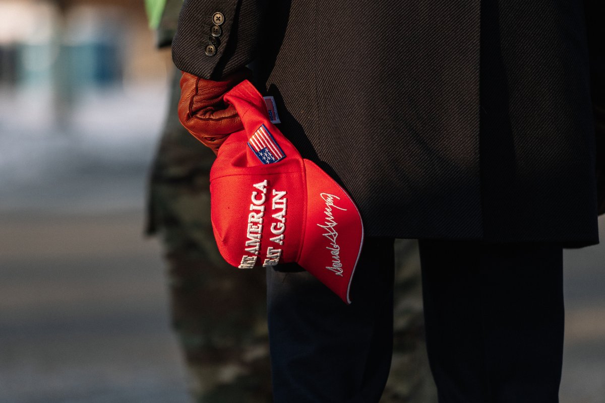 Pro-Trump supporter holding a MAGA hat 