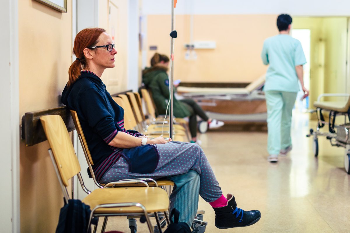 Woman Sitting In Hospital Waiting Room - 
