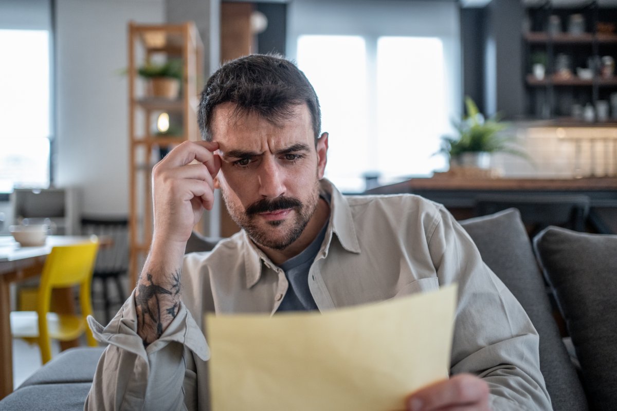 A man reads a note worried
