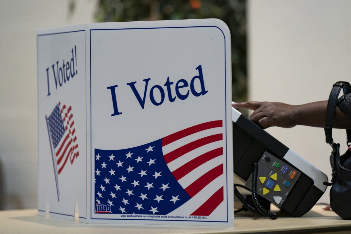 A person votes at a polling location A person votes at a polling location