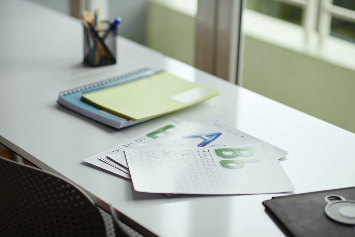 An organized workspace with spelling worksheets