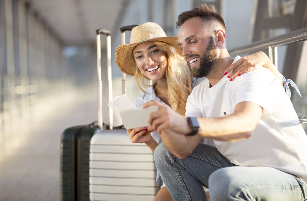 Smiling couple seated at the airport.