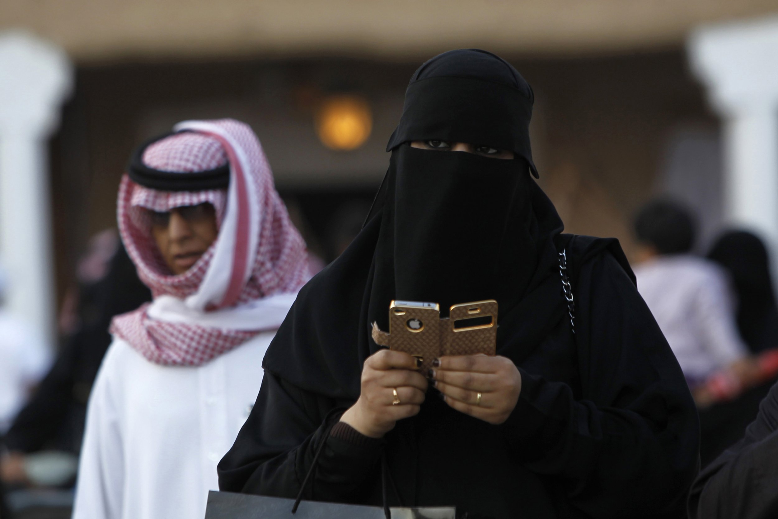 A woman using an iPhone visits the 27th Janadriya festival on the outskirts...