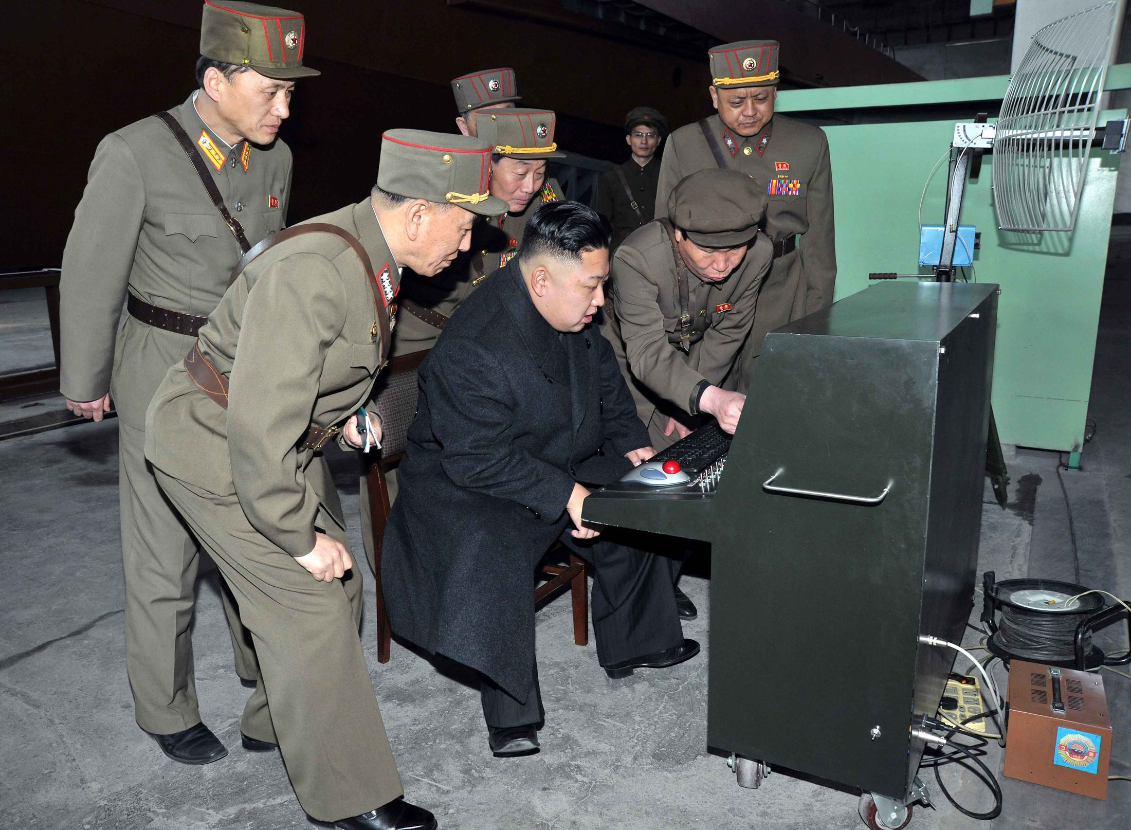 North Korean leader Kim Jong Un, center, looks at the latest combat and tec...