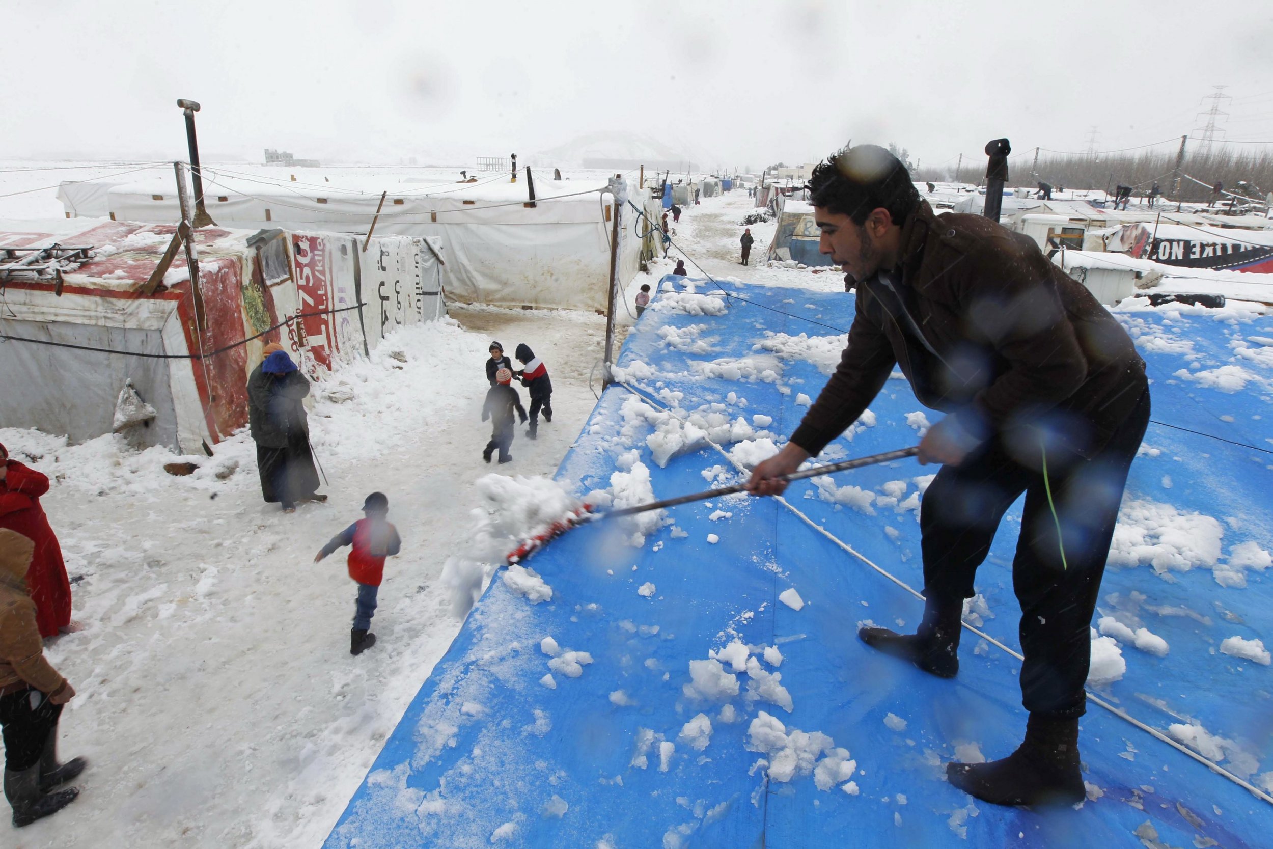 Photos: Syrian Refugees Hit By Rare Snowstorm In Lebanon - Newsweek