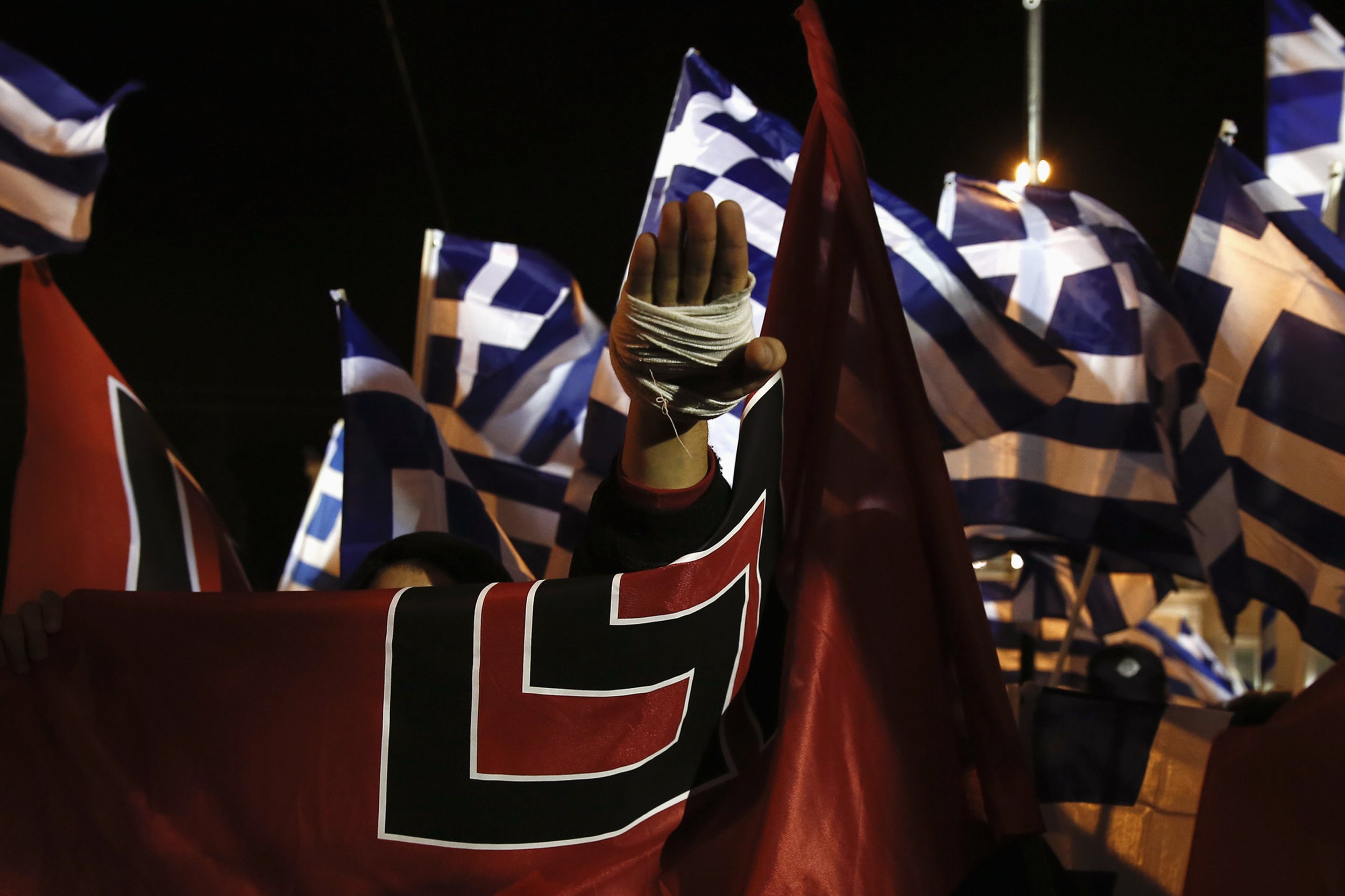 A supporter of Greece's far-right Golden Dawn party salutes in a Nazi style