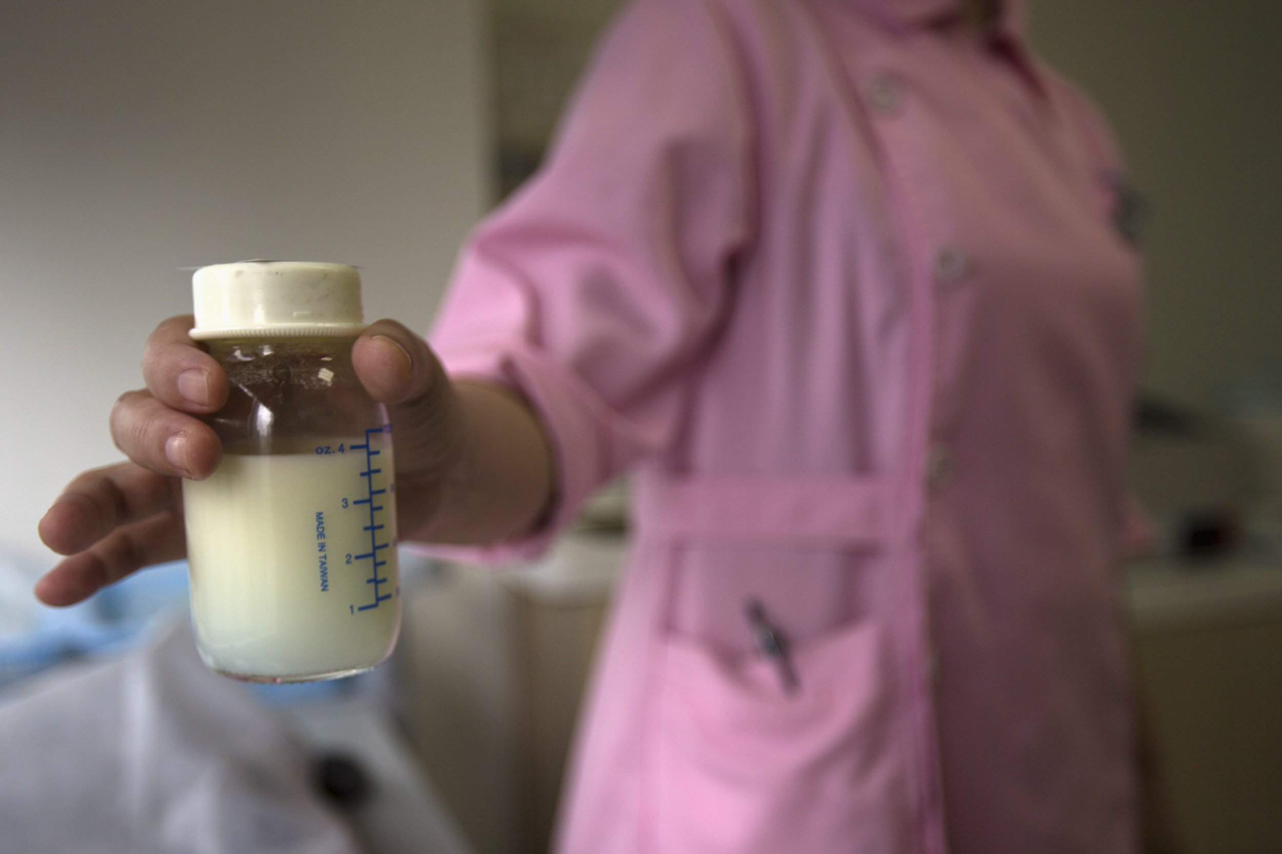 A nurse holds a bottle of donated breast milk, May 8, 2013.