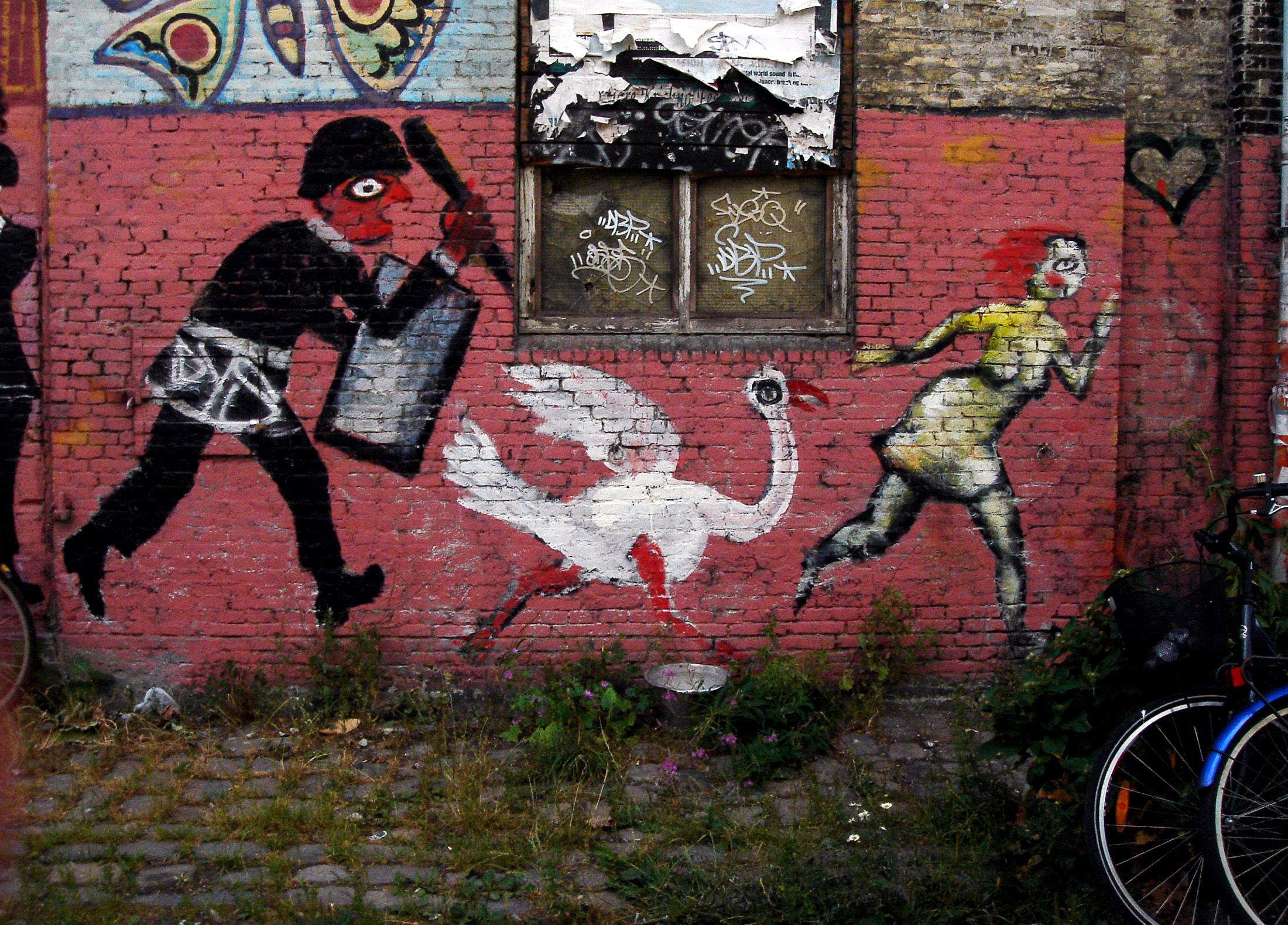 A painting of a police raid on a wall in Christiania, Denmark