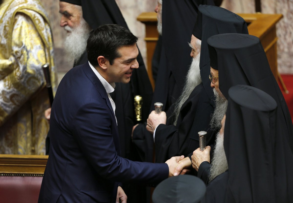 Greek Prime Minister Alexis Tsipras greets Orthodox priests in the Greek parliament in Athens