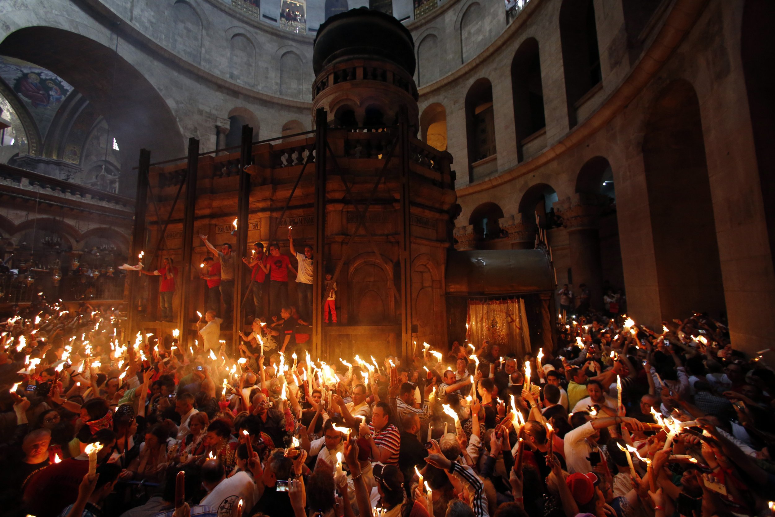 Worshippers hold candles as they take part in the Christian Orthodox Holy Fire ceremony in Jerusalem.