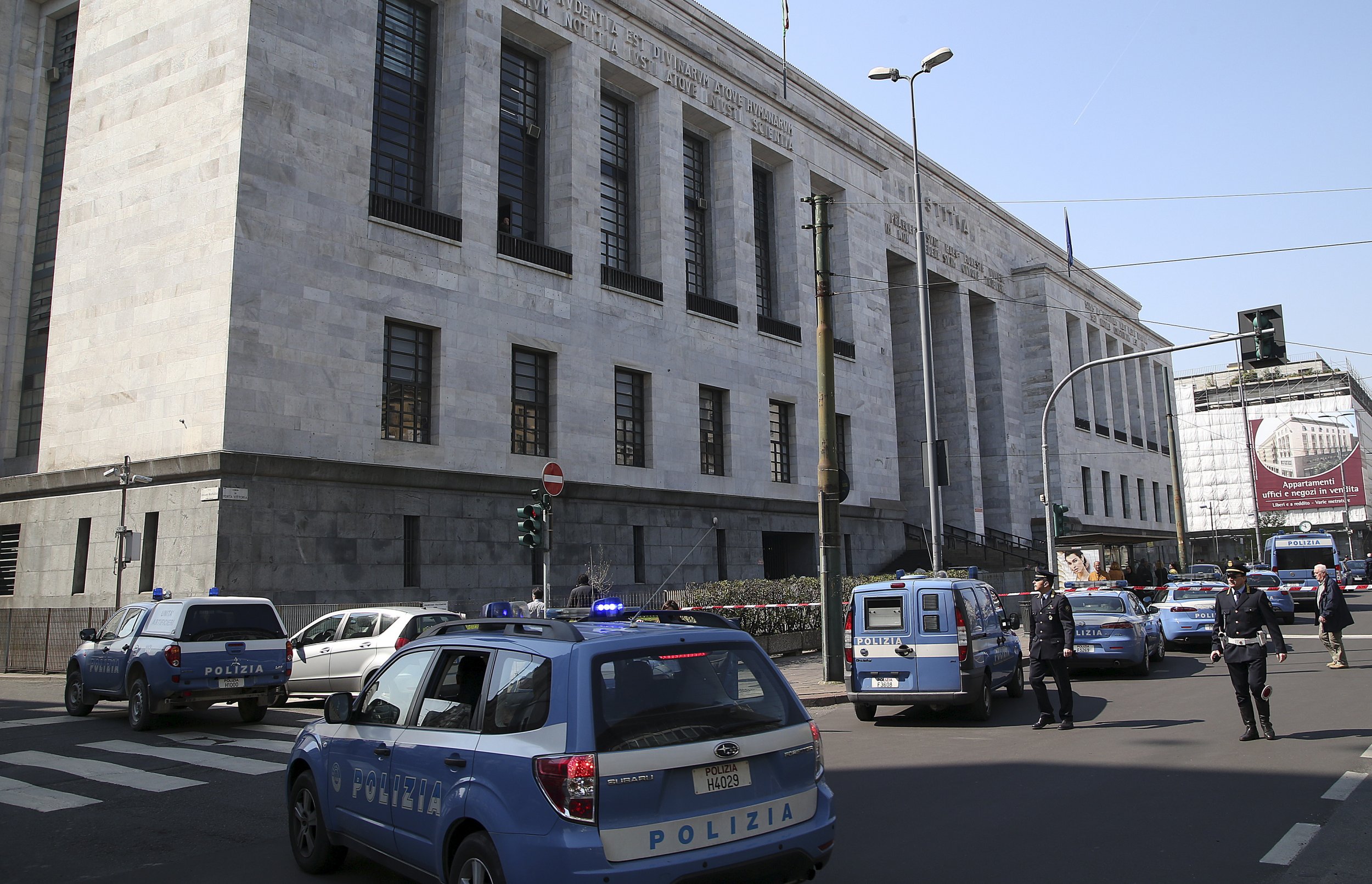 Police cars surround the tribunal of Milan April 9, 2015.