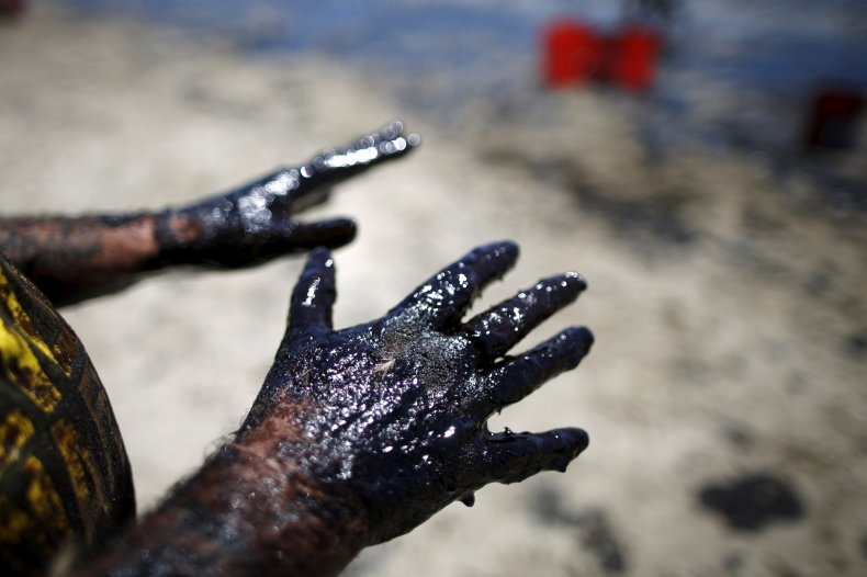 Volunteers clean crude oil off the beach Volunteers clean crude oil off the beach