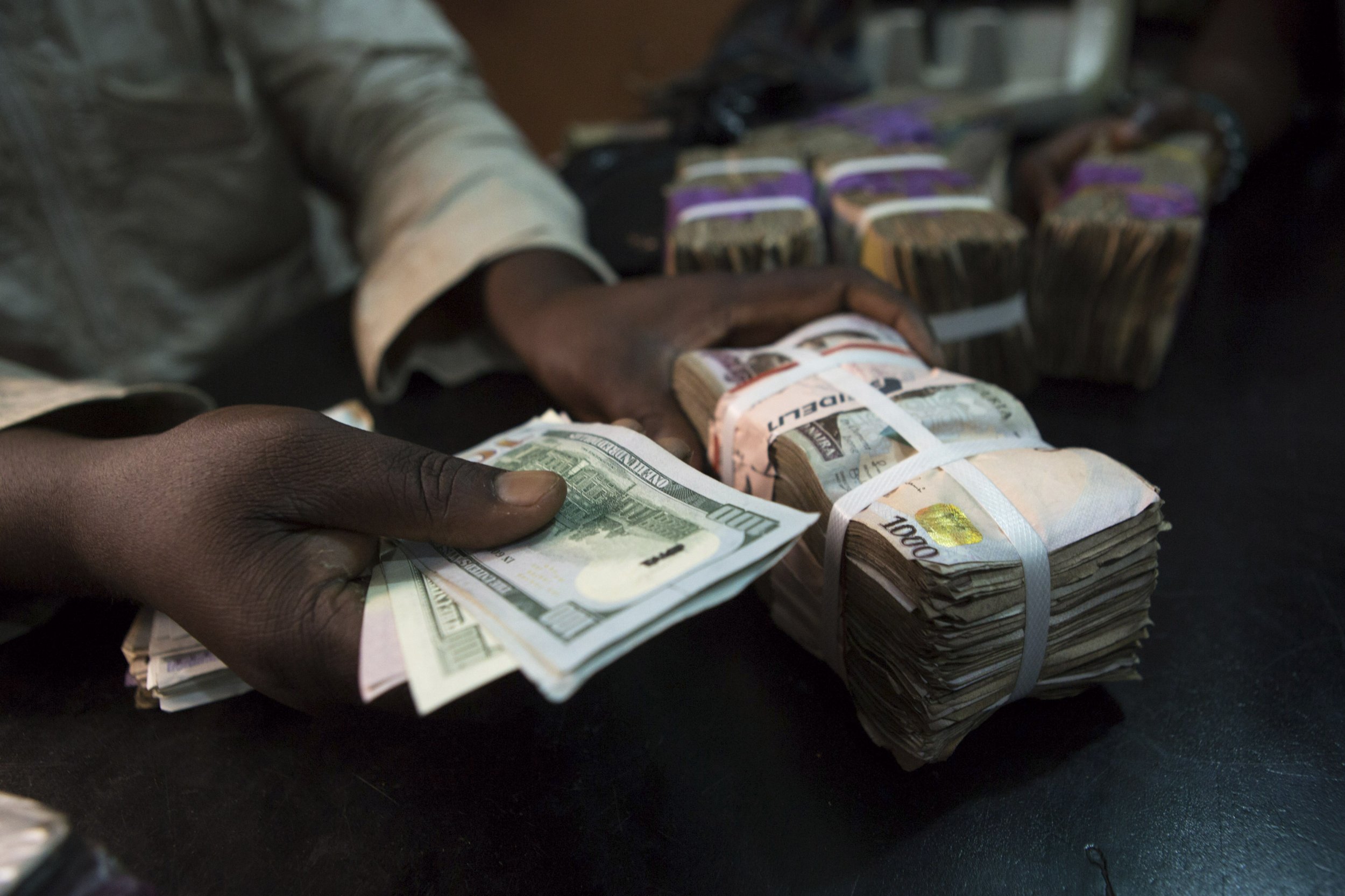 A trader changes dollars with naira in Lagos