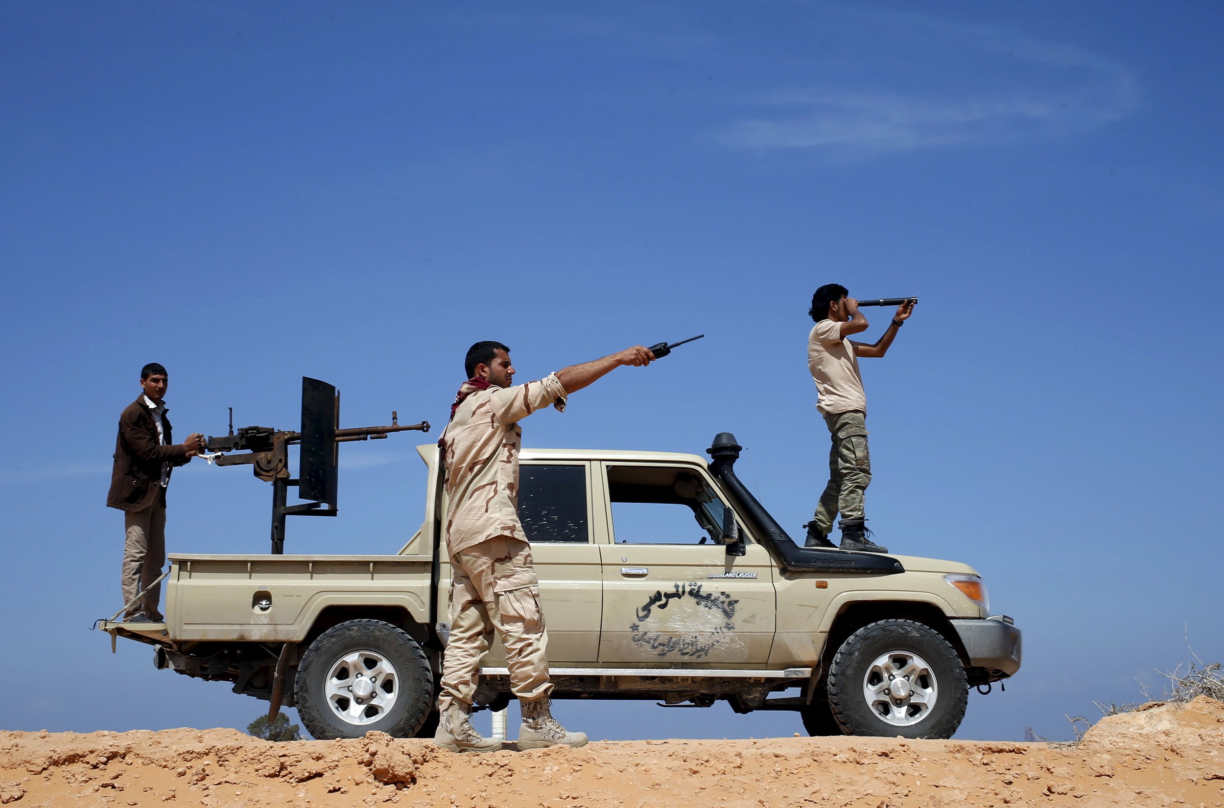 Libya Dawn fighters look at ISIS military positions near Sirte.