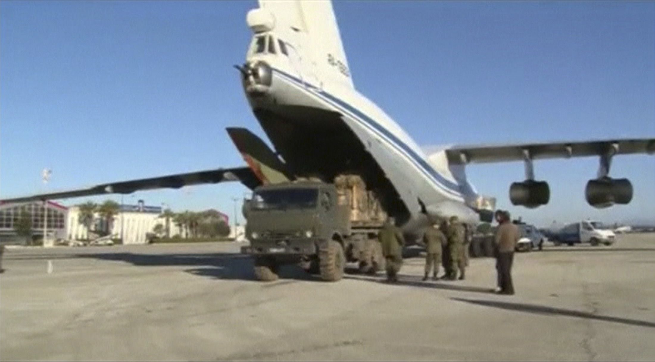 Russian cargo plane is being loaded at an airstrip