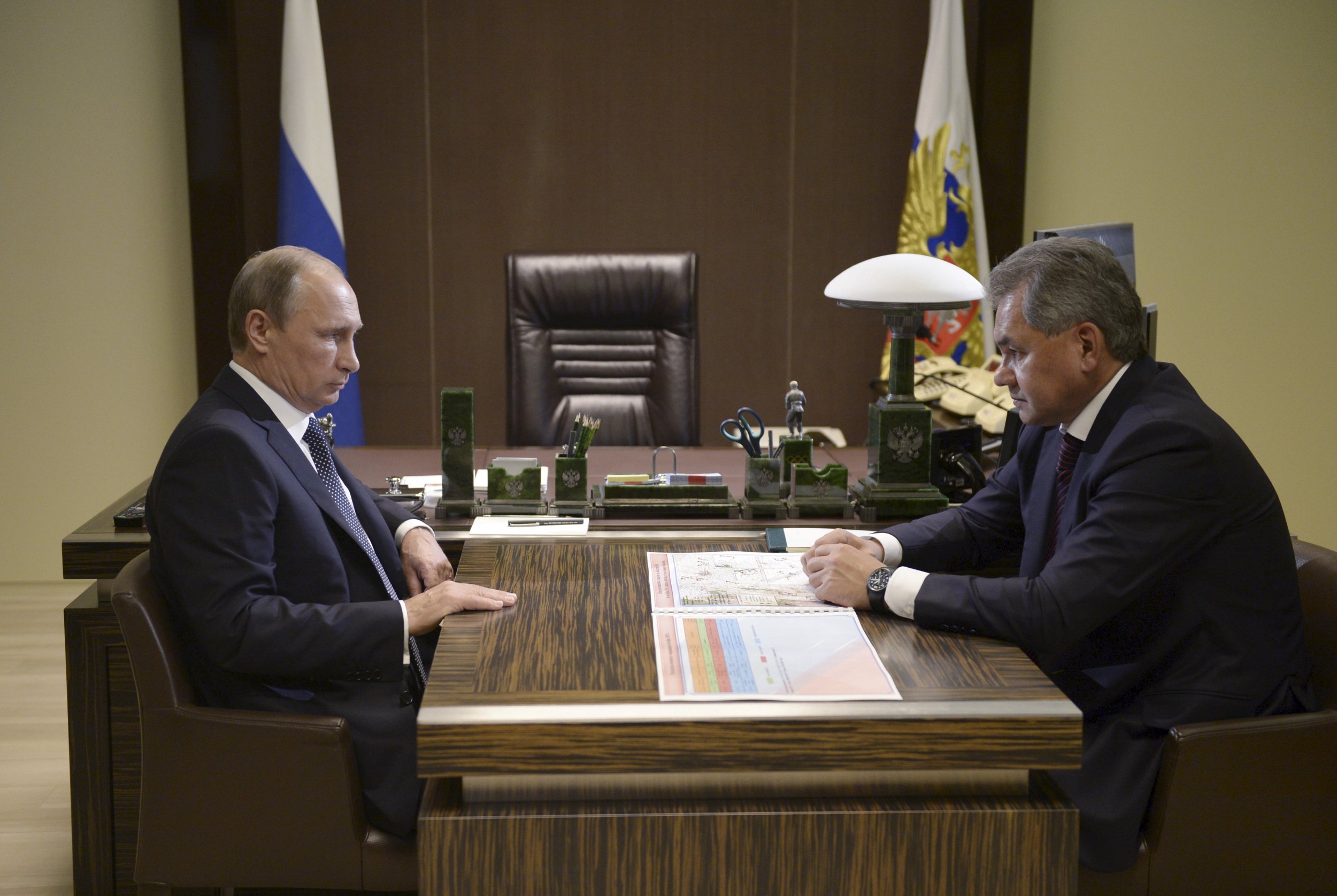 Putin sits opposite Shoigu at his desk