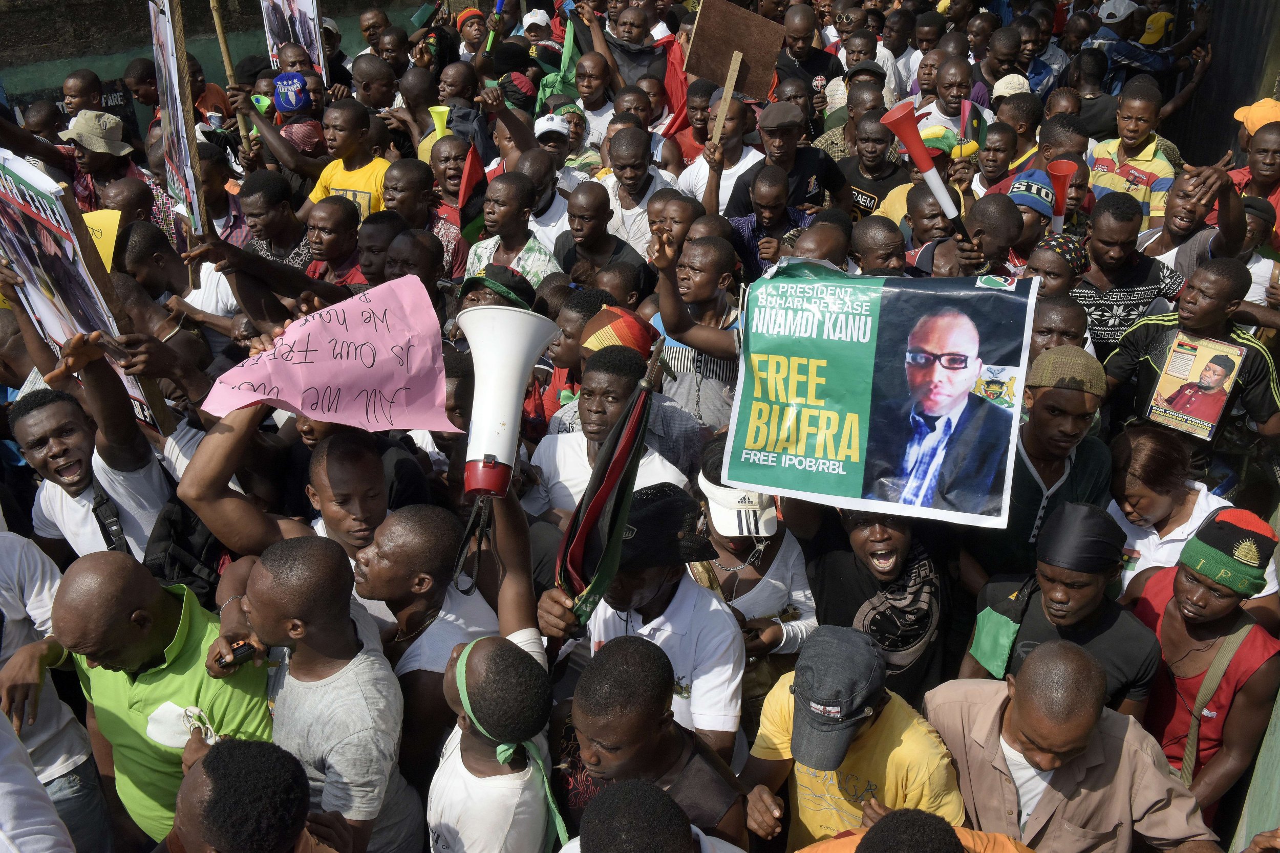 Pro-Biafra supporters carry a poster of Nnamdi Kanu at a protest in Aba, Nigeria.