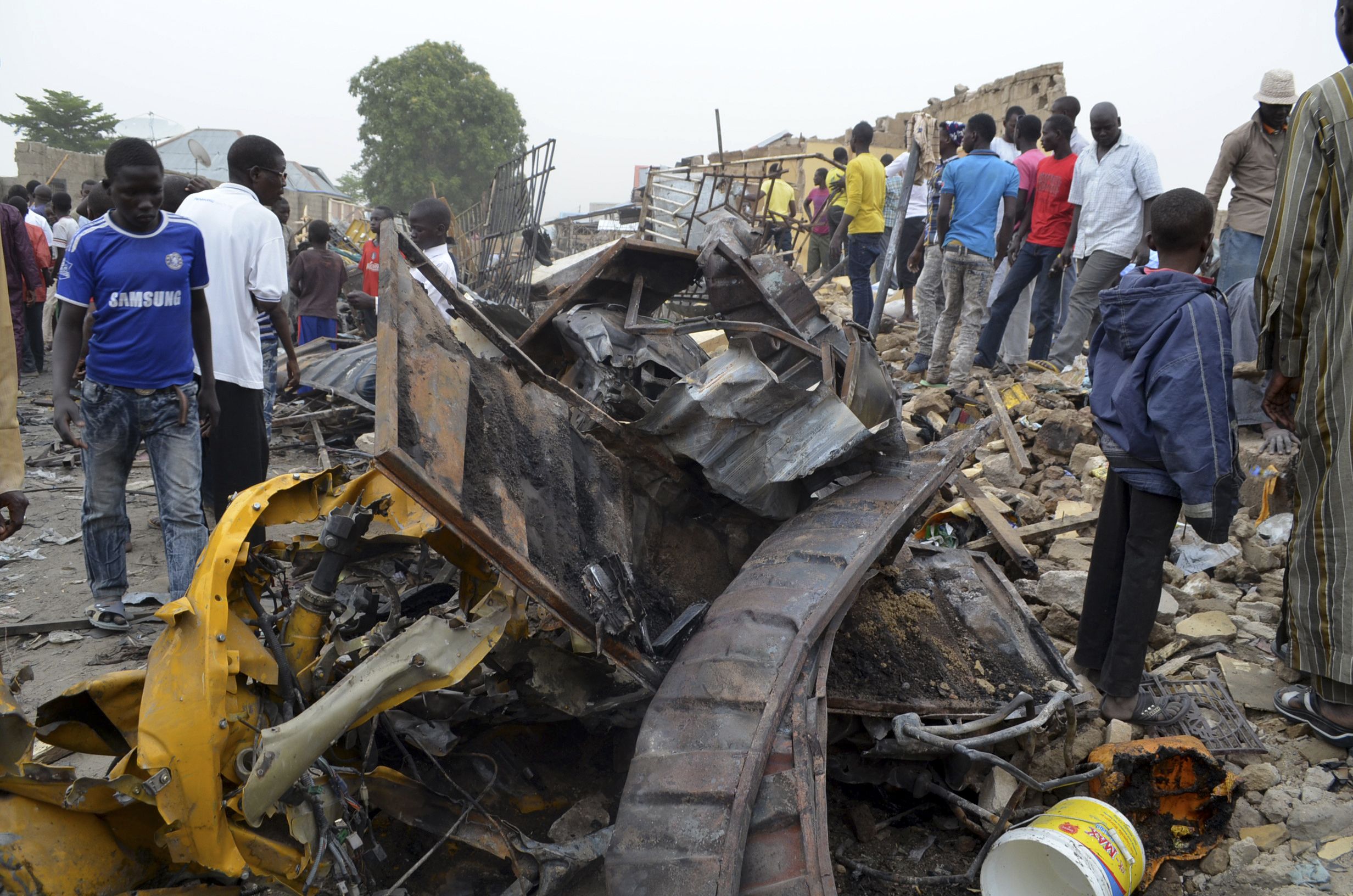 People inspect damage after an explosion in a market in Maiduguri, where Boko Haram are active.