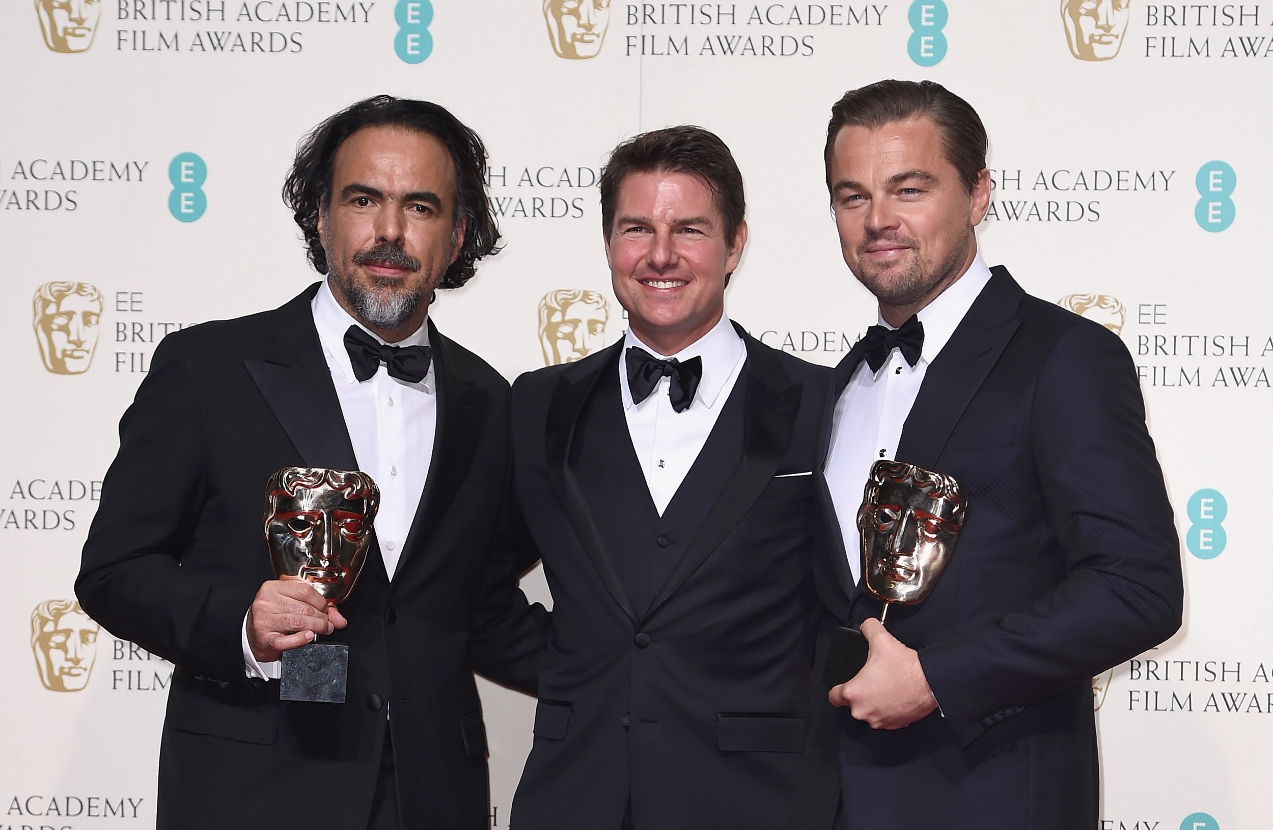 Alejandro Inarritu and Leonardo DiCaprio show off their awards with Tom Cruise.