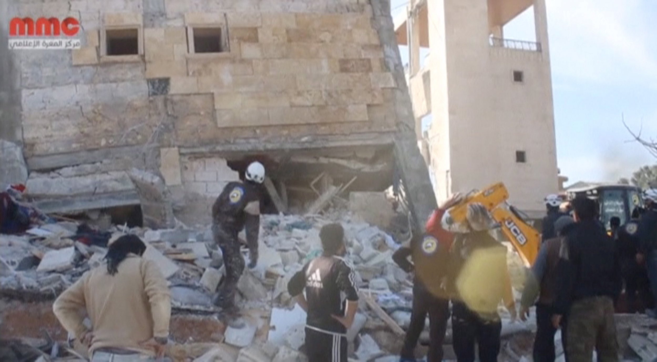 People gather near an MSF-supported hospital in Idlib, which was reportedly hit by airstrikes.