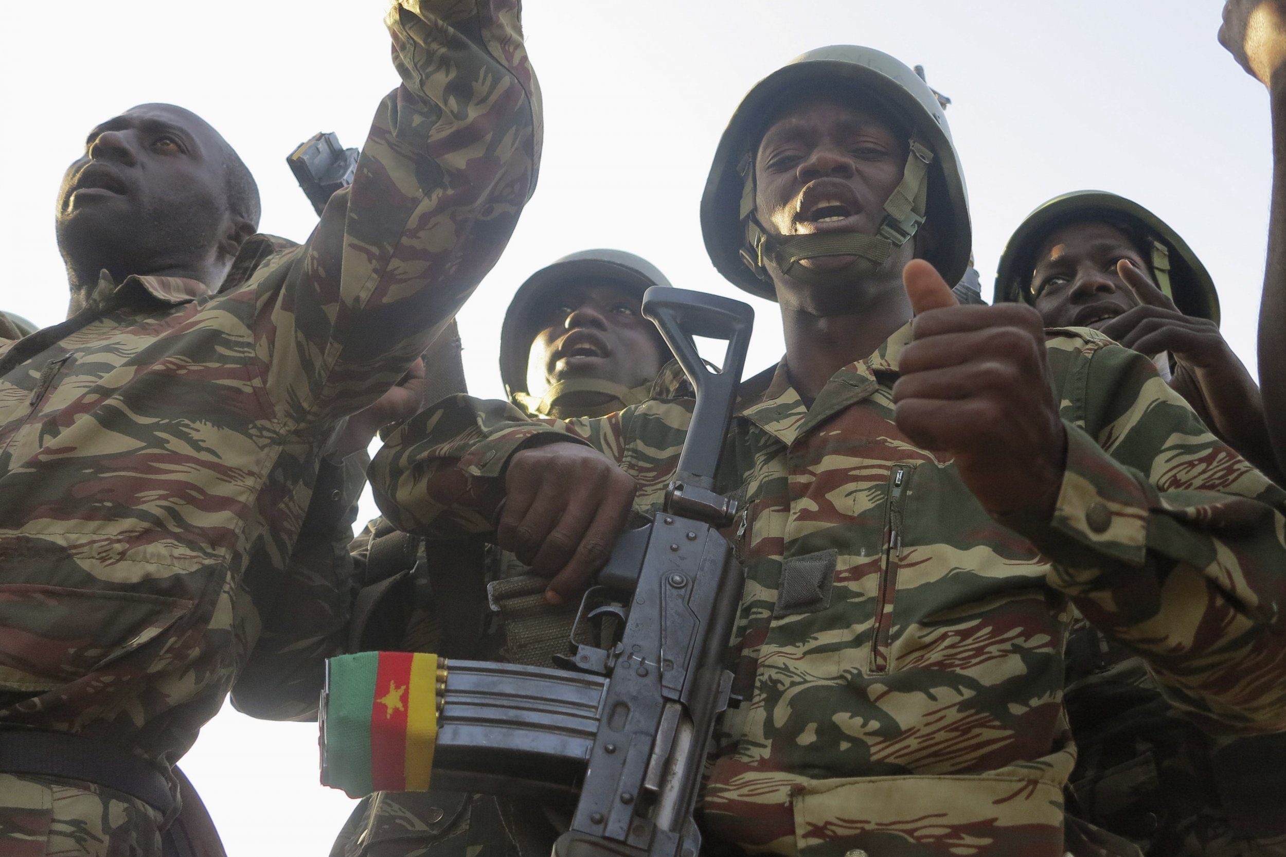 Cameroonian soldiers sing and dance.